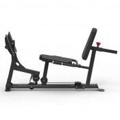 Benpressmaskin med lång stålram, justerbar sits och fotplatta framtill, sedd från sidan.