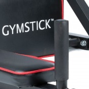 Detaljbild på vadderad yta med Gymstick-logotyp på svart klädsel, mot vit bakgrund.